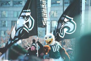 The Mascot for the Philadelphia Eagles, surrounded by fans carrying Eagles flags