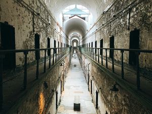 The long hallway in one of the wings of Eastern State Penitentiary, with decaying cells on either side