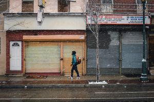 A man walking along a snowy 40th Street in University City Philadelphia